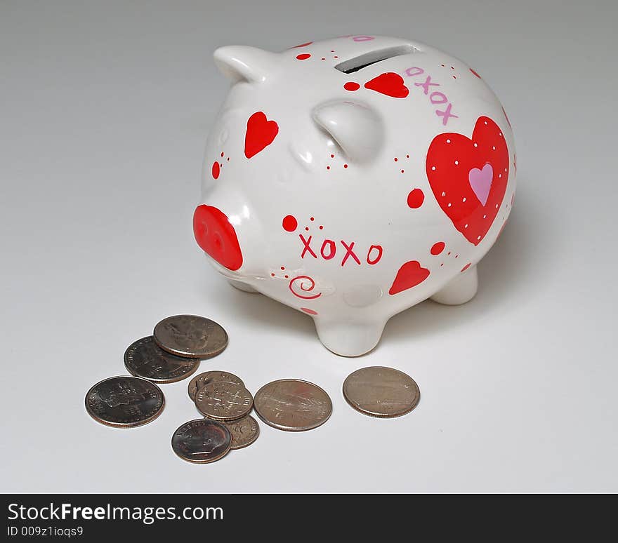 Piggy bank and coins on white background