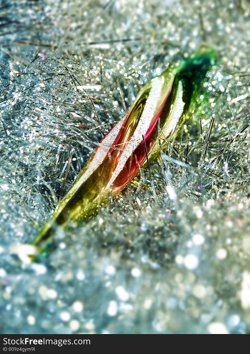 Partial blurred christmas decoration coloured icicle on glare background