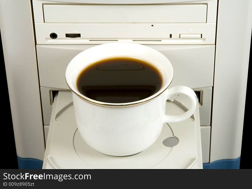 Cup of black coffee on CD-ROM, isolated on black