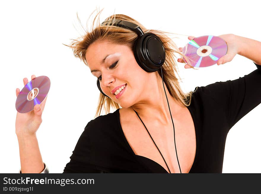 Beautiful young woman listening music in headphones and holding two CD