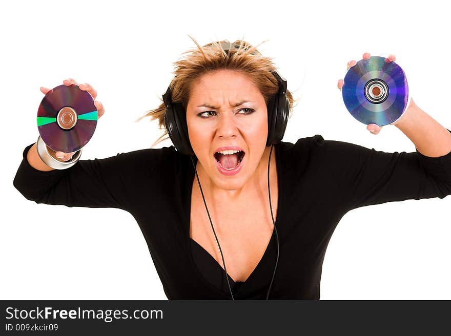 Beautiful young woman listening music in headphones and holding two CD