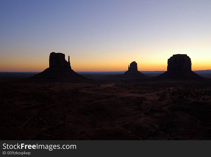 The silhouettes of the two Mittens against the predawn sky at Monument Valley (Navajo Nation, Utah). The silhouettes of the two Mittens against the predawn sky at Monument Valley (Navajo Nation, Utah).