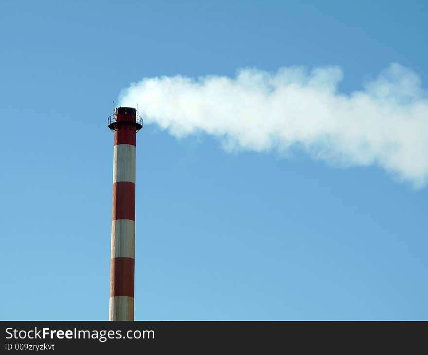 Industrial chimney in factory expelling smoke in the atmosphere