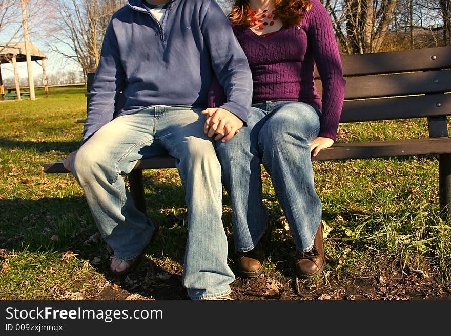 Young couple on park bench. Young couple on park bench