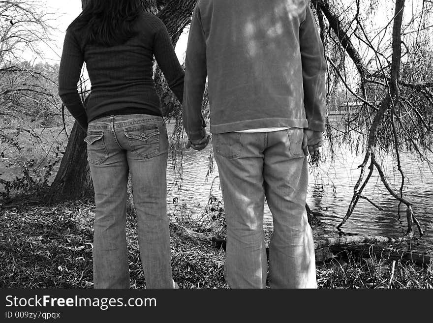 Young couple sitting under a tree. Young couple sitting under a tree