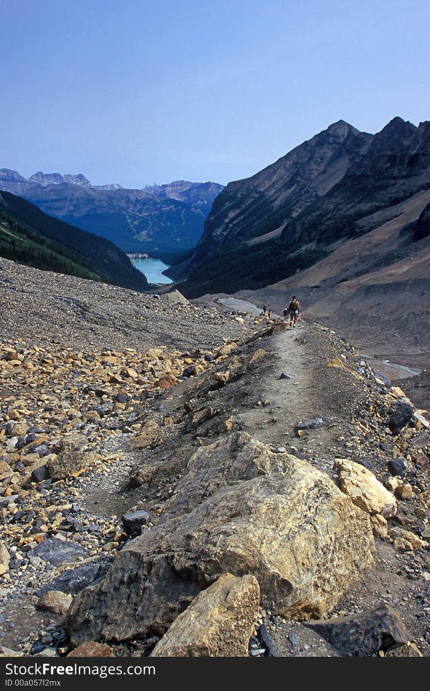 Hiker on trail above Lake Louise