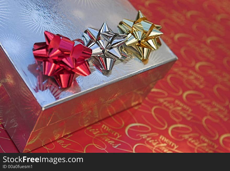 Detail of different coloured bows on a christmas present. Detail of different coloured bows on a christmas present