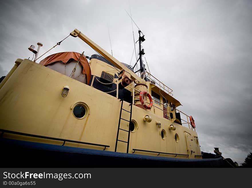 The side of a tugboat tied up in Halifax harbour.