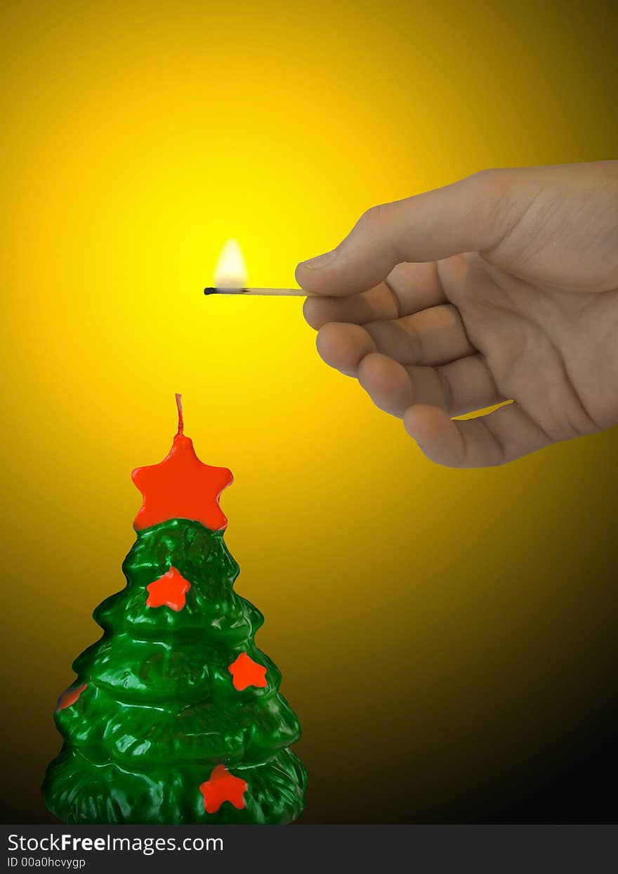 Candle (xmas tree) and hand with match