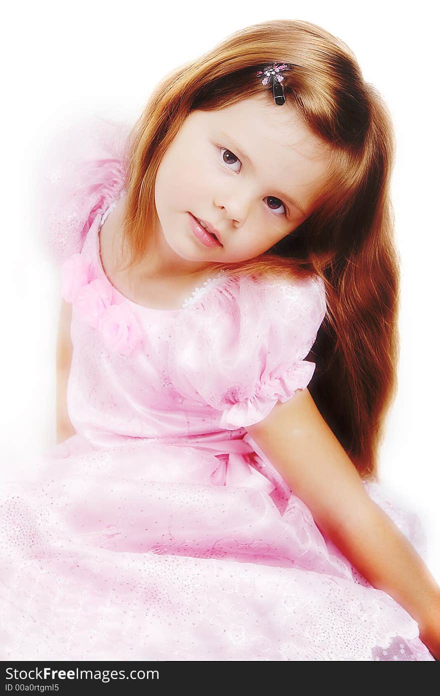 Happy little princess with a beautiful hair. Shot in studio. Happy little princess with a beautiful hair. Shot in studio.