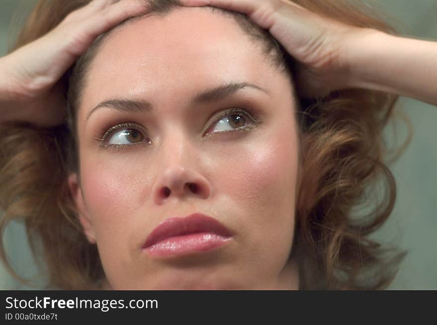 Beautiful brunette close head portrait with hands at her hair. Beautiful brunette close head portrait with hands at her hair