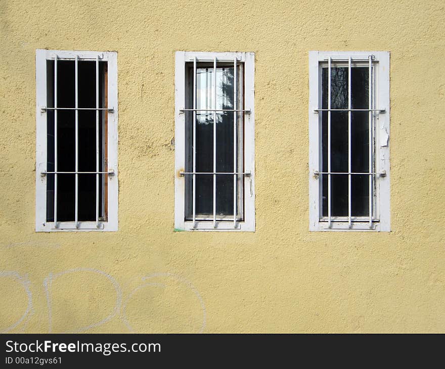 Three window with metallic shutter and yellow wall. Three window with metallic shutter and yellow wall