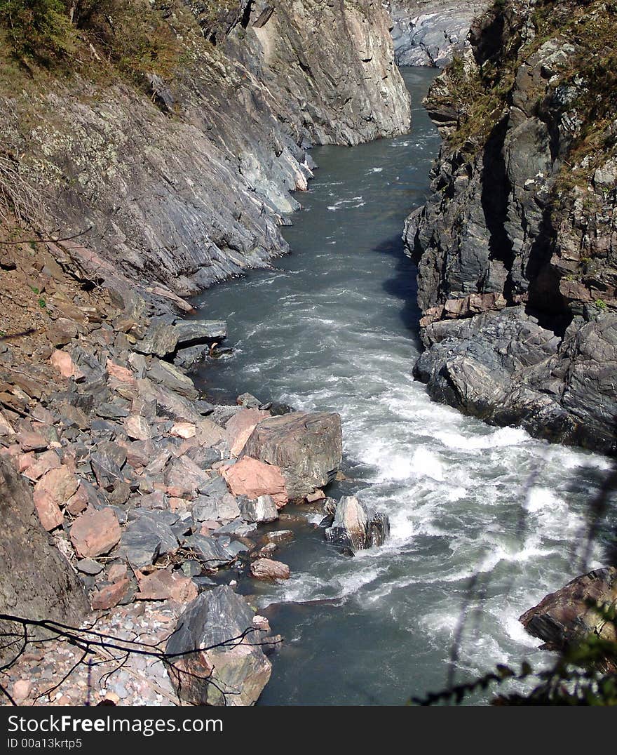 Stream of water between stony steep banks. Stream of water between stony steep banks