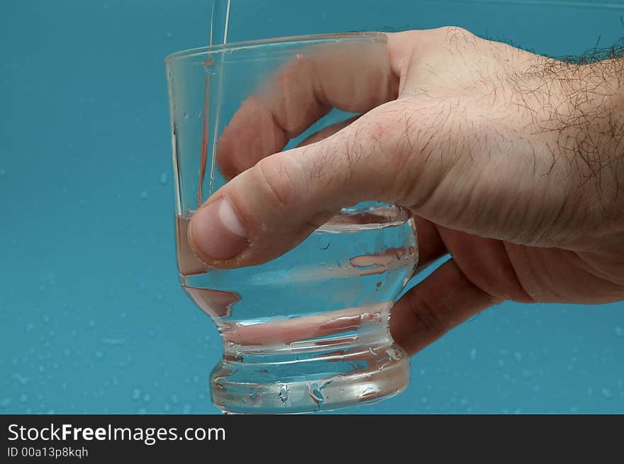 Hand keeping glass with water. Hand keeping glass with water