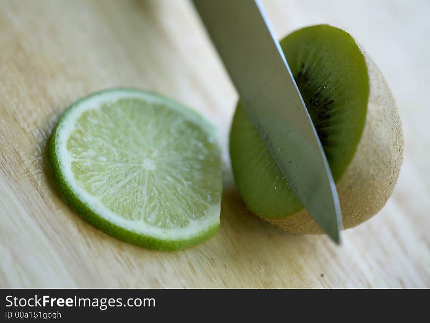 Close up of a kiwi and knife with lime slice. Close up of a kiwi and knife with lime slice