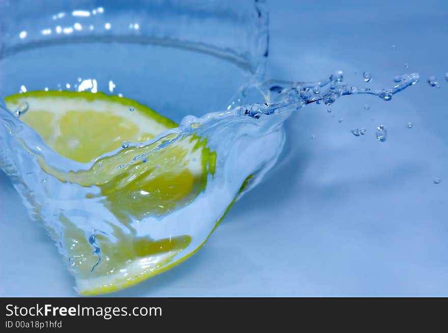 Lemon splashing into fresh water