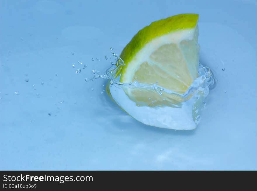 Lemon splashing into fresh water