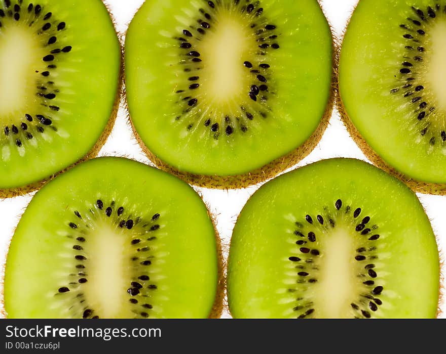 Kiwi fruit slices aligned on white background. Kiwi fruit slices aligned on white background