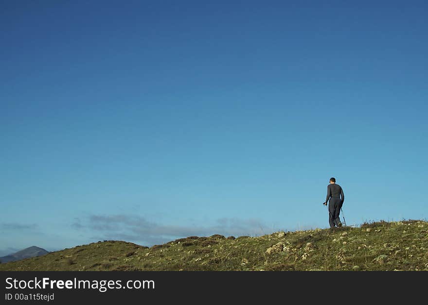 Men going up on the green hill. Men going up on the green hill