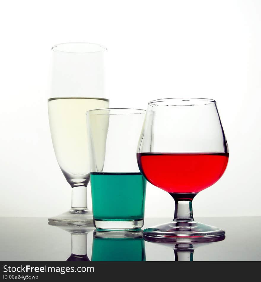 Colored drinks in different cups and glasses