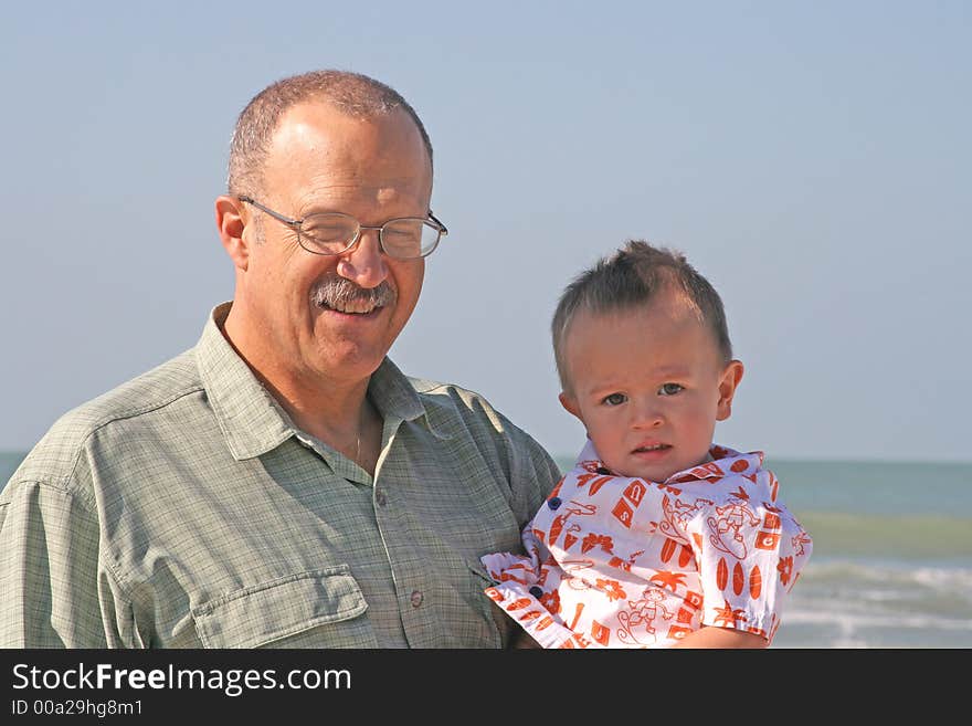 Grandfather and grandson at beach on vacation in southwest Florida