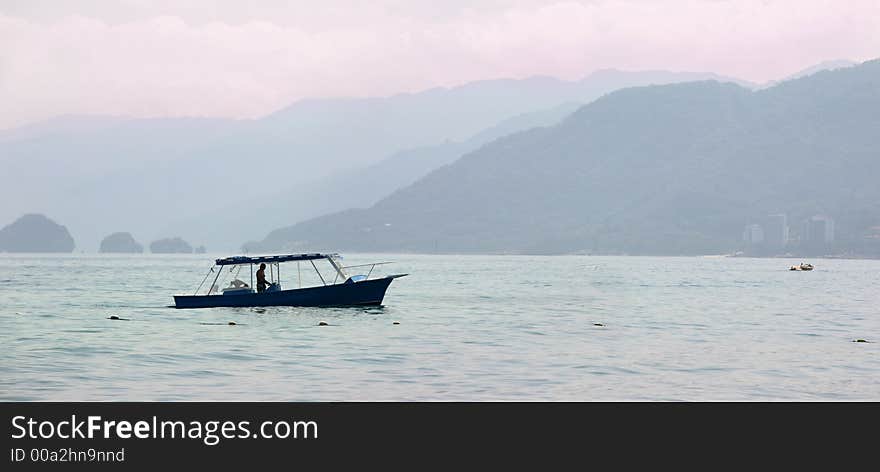 Fisherman on his boat in the bay at sunrise. Fisherman on his boat in the bay at sunrise