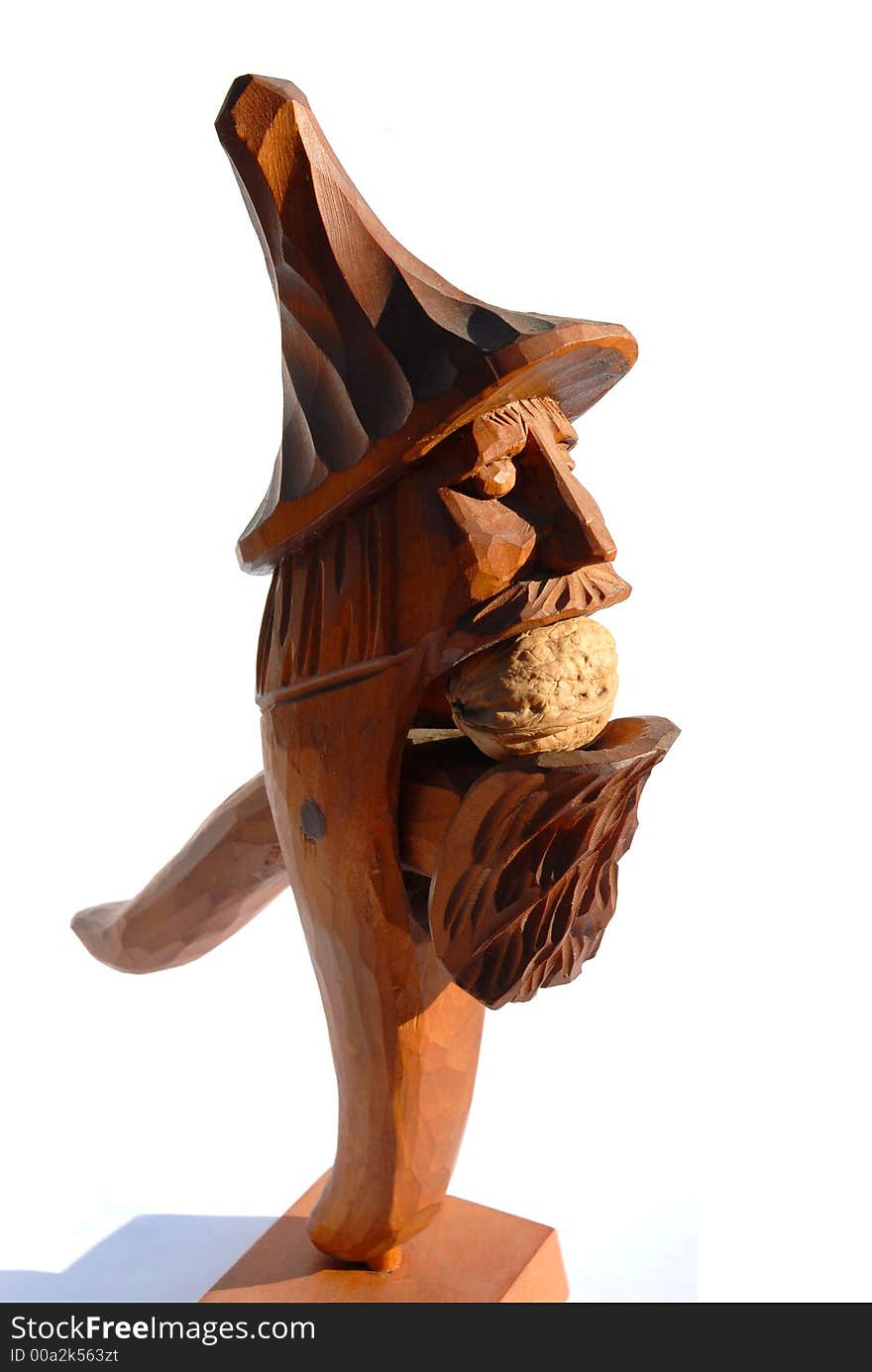 Nutcracker in shape of folk sculpture with walnut inside. Nutcracker in shape of folk sculpture with walnut inside