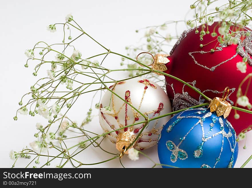 Three christmas balls with green branch. Isolated, white background