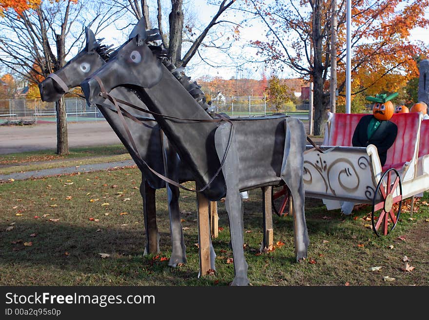 Pumpkin people in a horse and carriage. Celebrating the start of the harvest season and Halloween in Canada. Pumpkin people in a horse and carriage. Celebrating the start of the harvest season and Halloween in Canada.