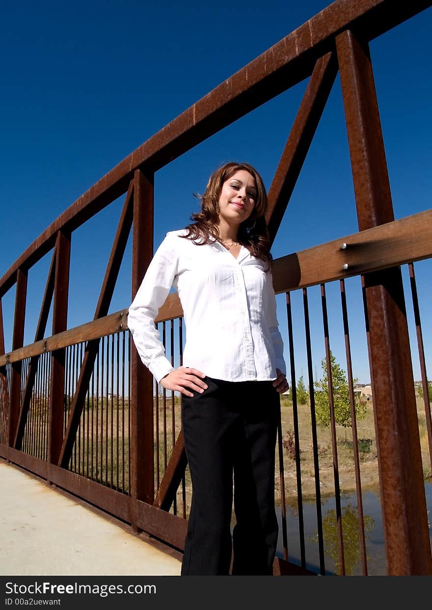 A pretty hispanic girl on a bridge. A pretty hispanic girl on a bridge.