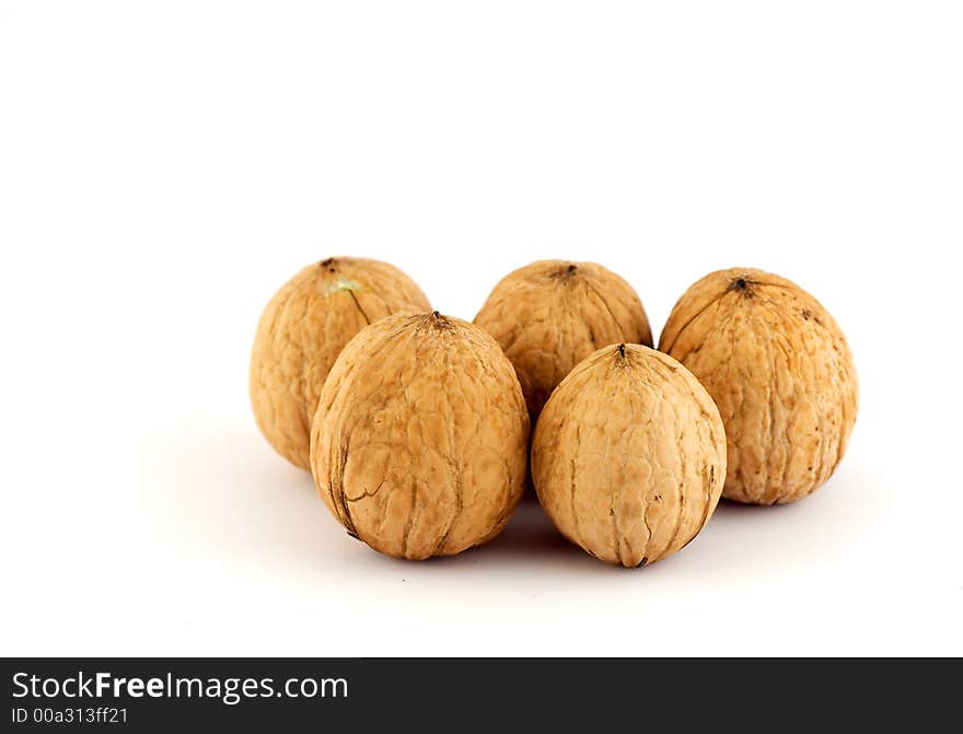 Five walnuts isolated on white