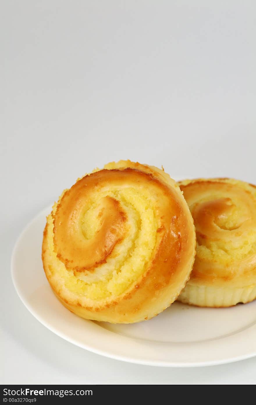 Two Sweet Buns on White Plate. Shallow DOF. Two Sweet Buns on White Plate. Shallow DOF.