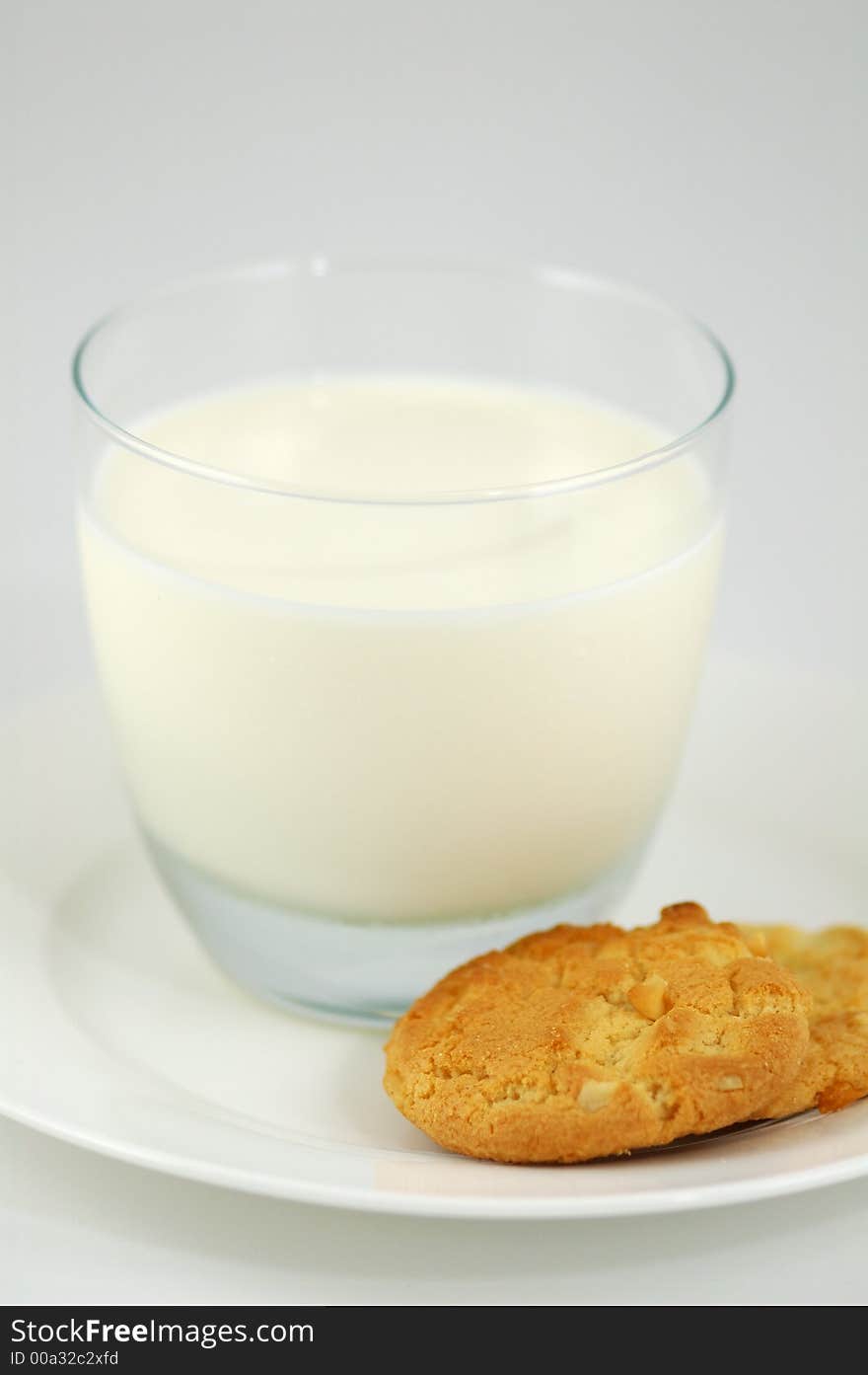 Cookies on White Plate and Glass of Milk. Shallow DOF. Cookies on White Plate and Glass of Milk. Shallow DOF.