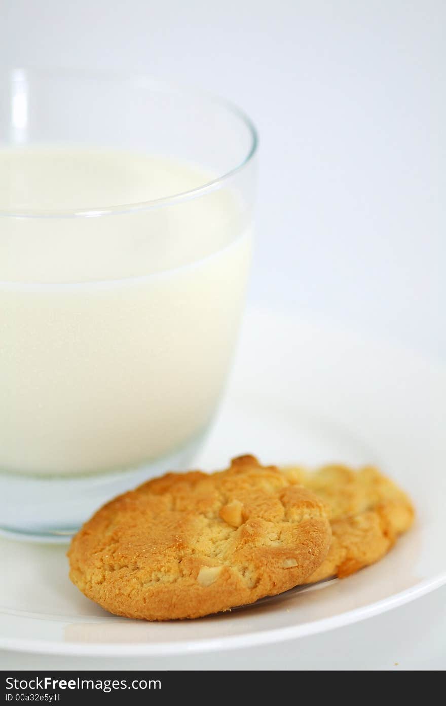 Cookies on White Plate and Glass of Milk. Shallow DOF. Cookies on White Plate and Glass of Milk. Shallow DOF.