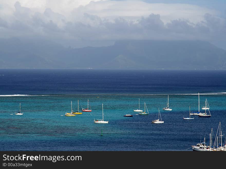 Pacific lagoon with boats at anchor