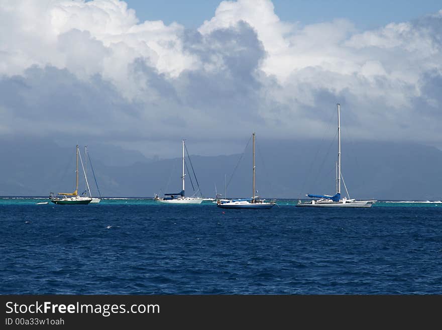 Tropical lagoon and sail boats at anchor. Tropical lagoon and sail boats at anchor