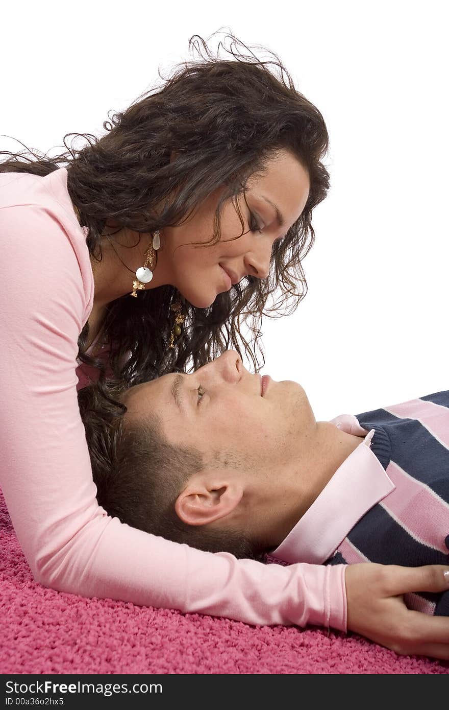 Young couple lying on the pink carpet - faces closeup