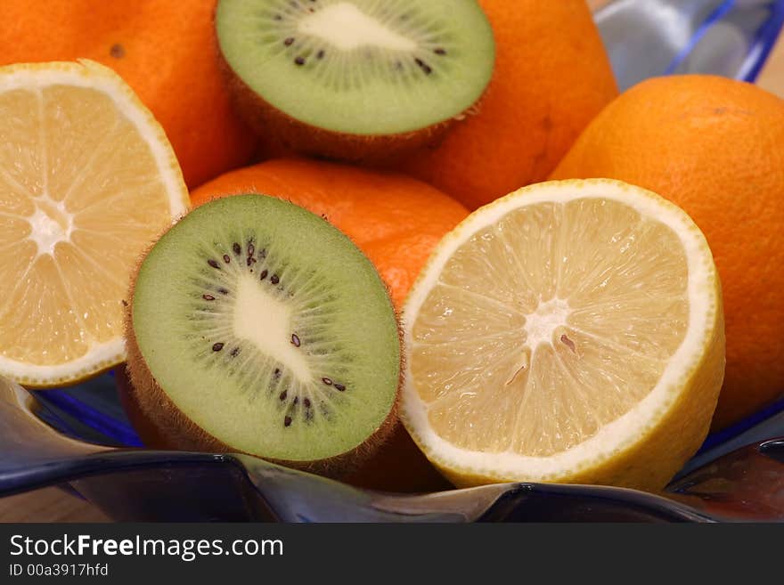 Fruit bowl with oranges, lemons and kiwi