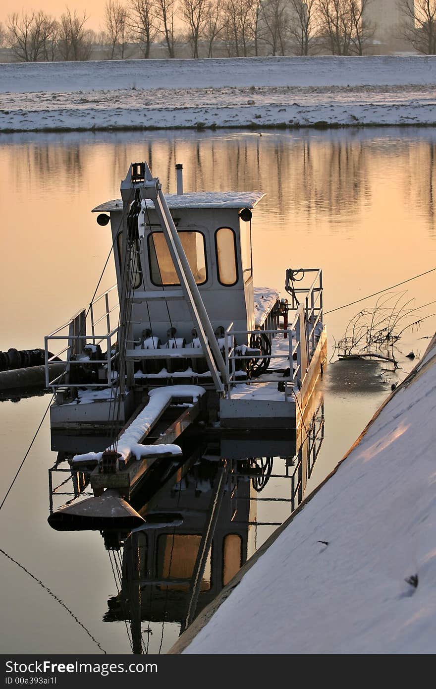 Cleaning boat on lake in winter