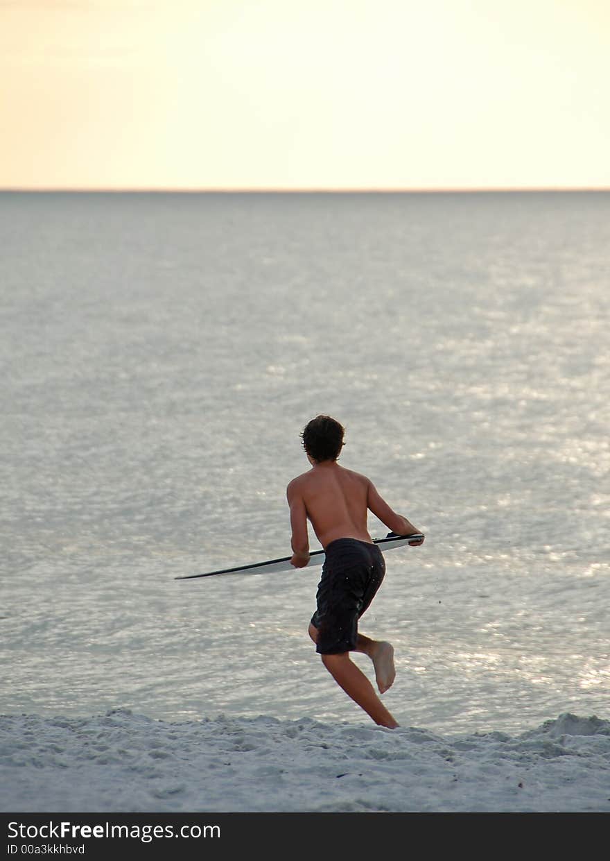 Young surfer on beach