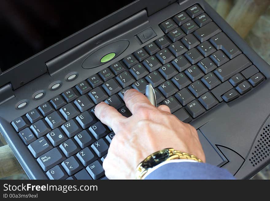 A business executive typing on a laptop. A business executive typing on a laptop