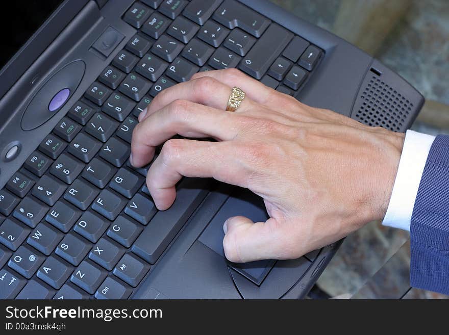 A business executive typing on a laptop. A business executive typing on a laptop