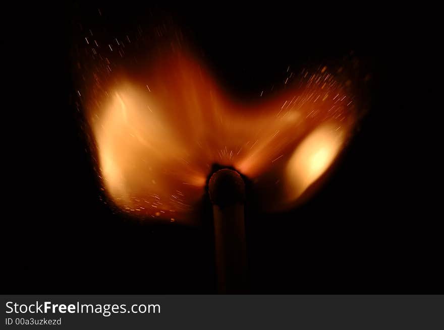 Single match burn on black background, isolated. Single match burn on black background, isolated