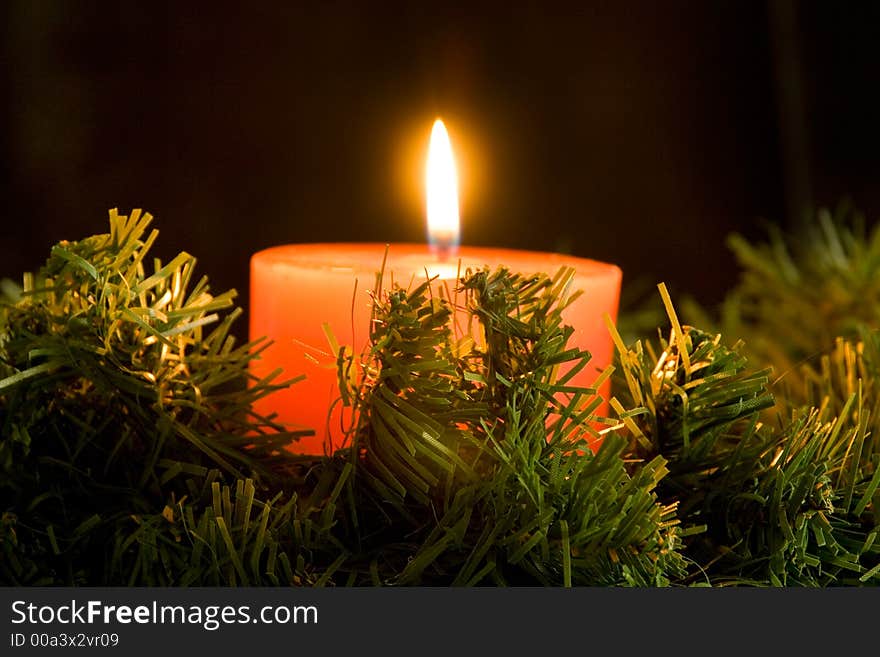 Red candle burning on black background