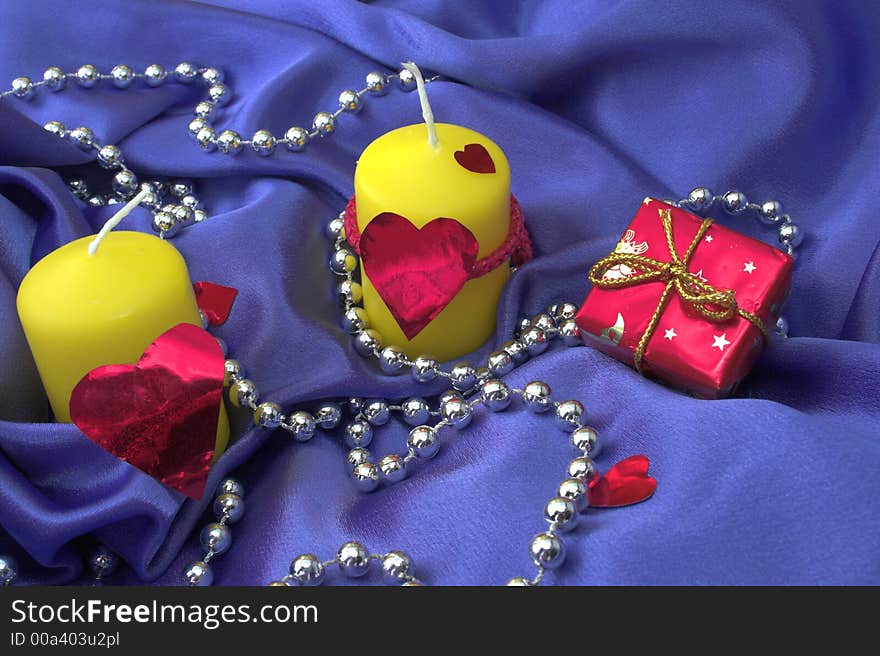 Two valentines yellow candles on a lilac background. Two valentines yellow candles on a lilac background