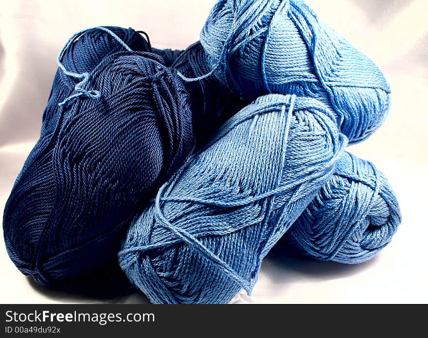 Knitting yarn in blue colors on white background. Knitting yarn in blue colors on white background