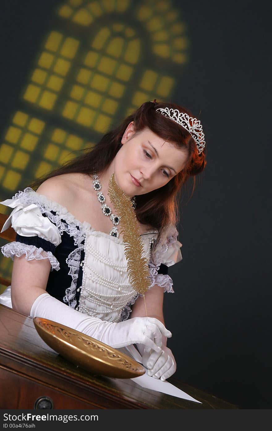 Girl in historic robe writing a letter