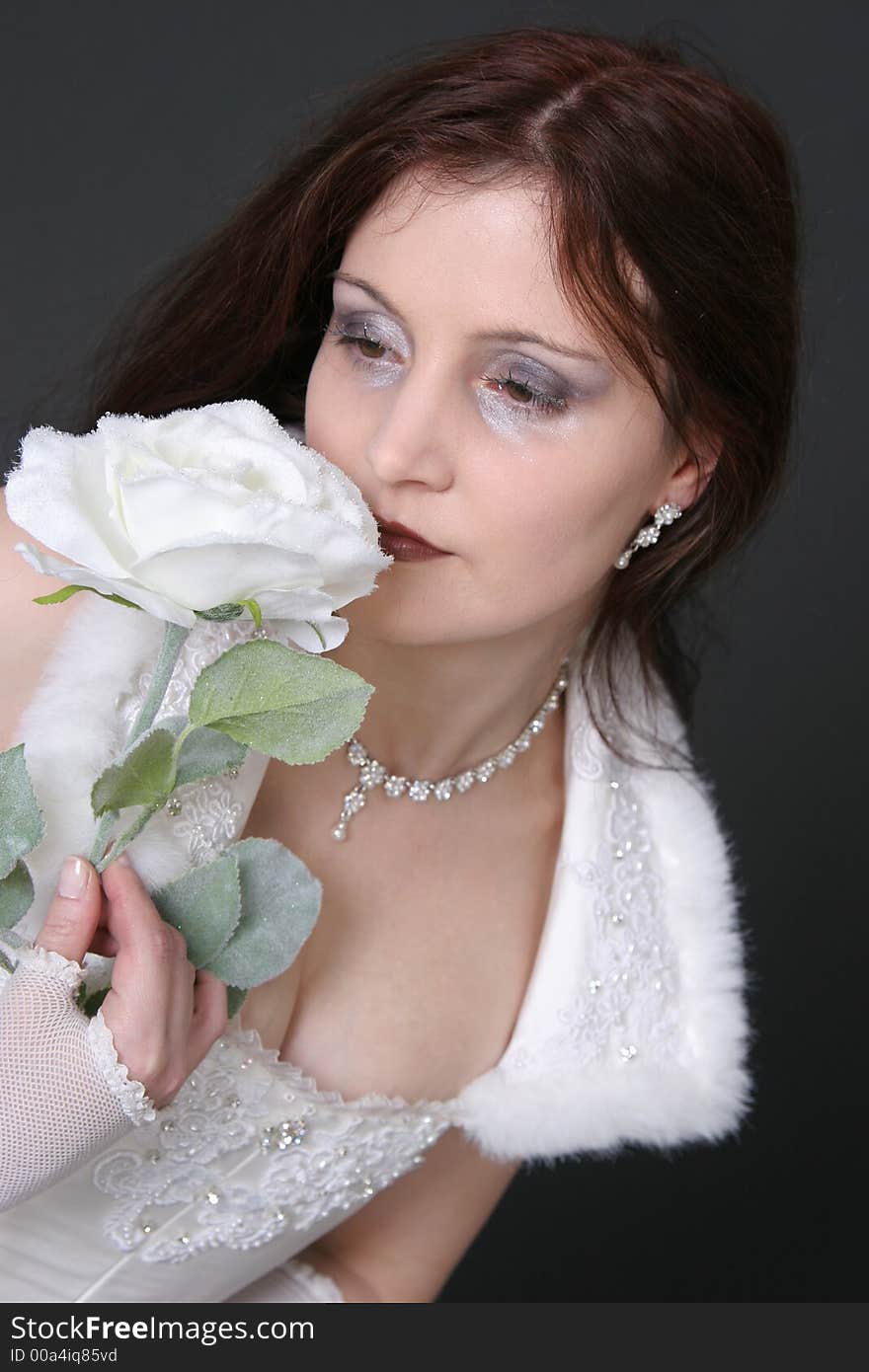 Portrait of a beautiful girl in white robe with flower. Portrait of a beautiful girl in white robe with flower