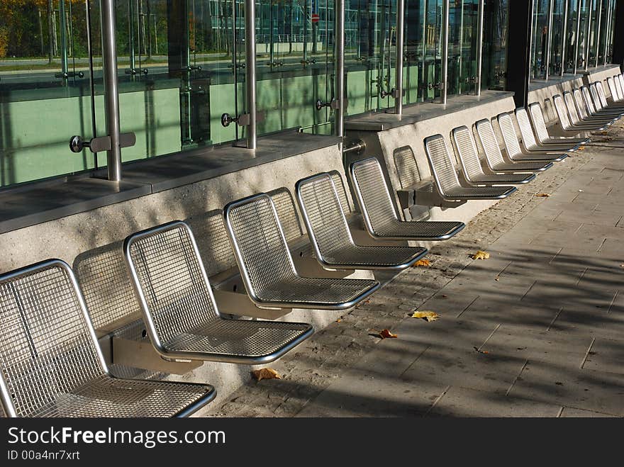 Empty seats closeup, taken at a bus stop in Munich, Germany. Aluminum frames. Empty seats closeup, taken at a bus stop in Munich, Germany. Aluminum frames.