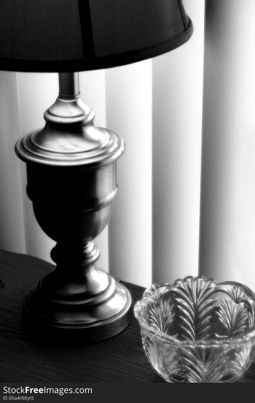 Black and White of Lamp on a table with verticle blinds. Black and White of Lamp on a table with verticle blinds